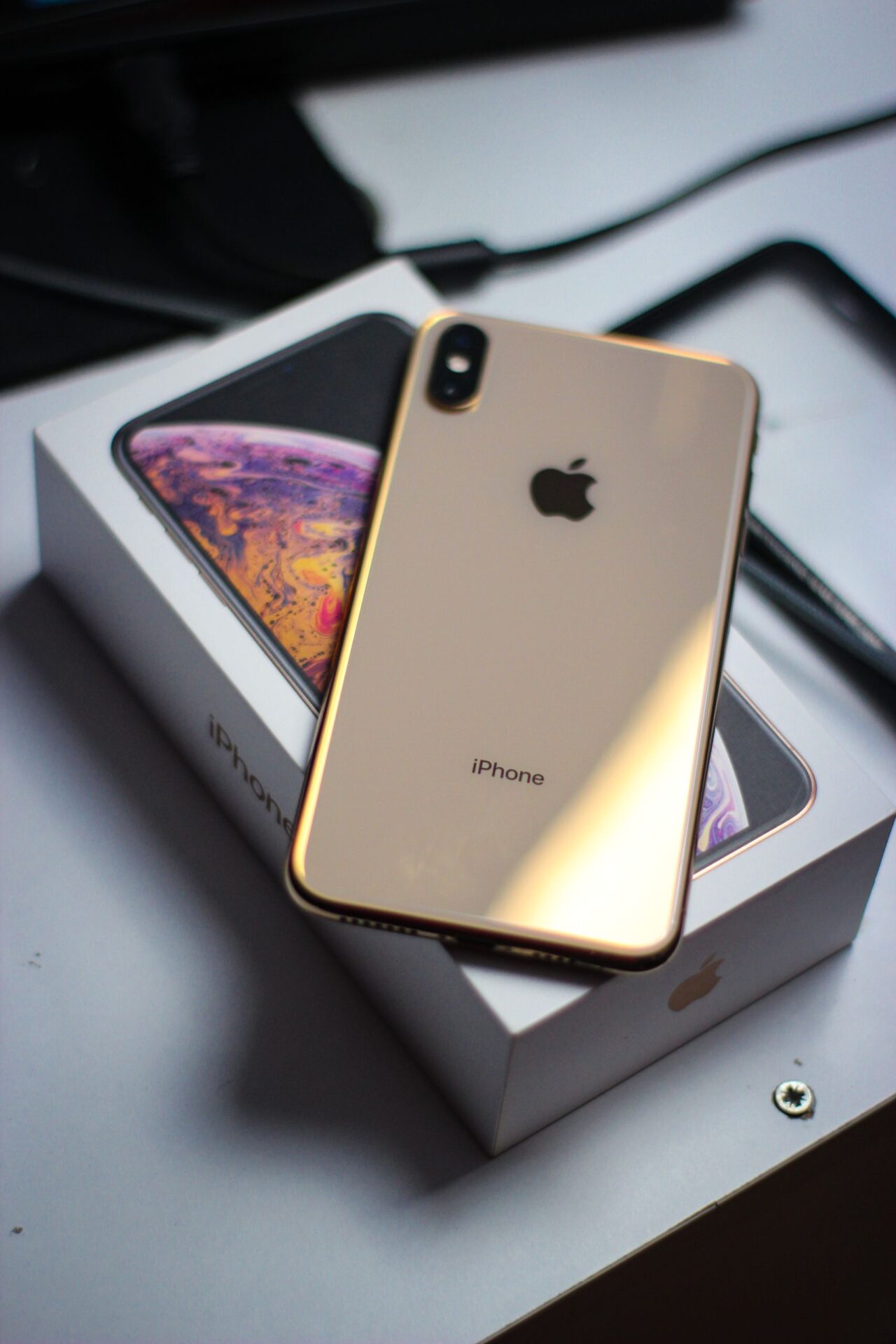 Close-up of a modern smartphone placed on its box, highlighting elegant design and tech innovation.