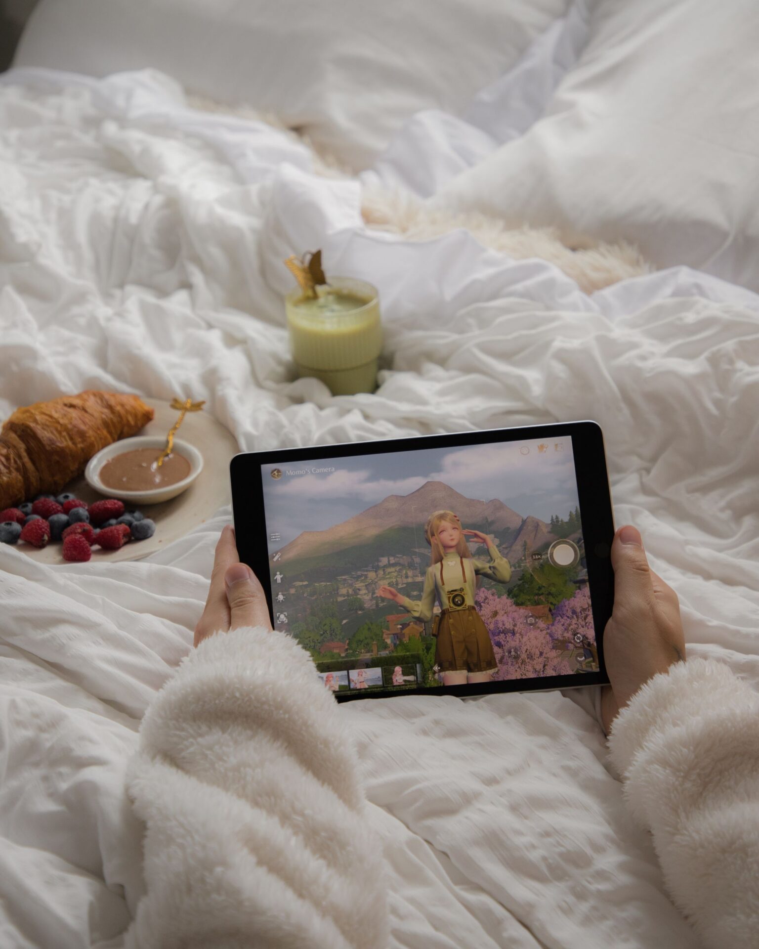 Relaxing morning with tablet gaming and breakfast in a cozy setting.